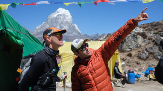 LHO Expedition Coordinator Rami Rasamny explains the route to the summit from Ama Dablam Base Camp to a visiting trail runner during the Climb Ama Dablam Expedition with Life Happens Outdoors.