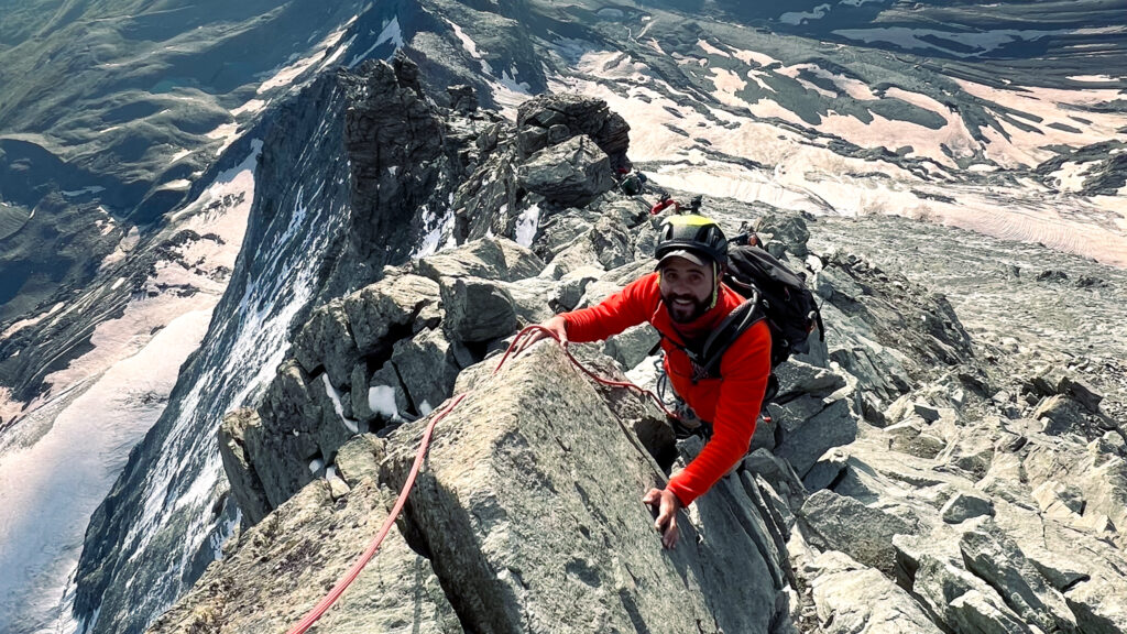 LHOer Jean Louis Moukarzel on the final ridge beneath the summit of the Matterhorn just after sunrise during the Climb Matterhorn Course with the Life Happens Outdoors team.