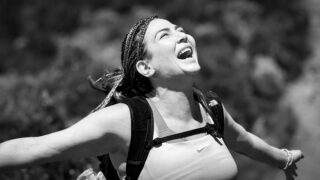 Life Happens Outdoors climber expressing pure joy at Horombo Hut on Mount Kilimanjaro, captured in a candid moment of bliss.