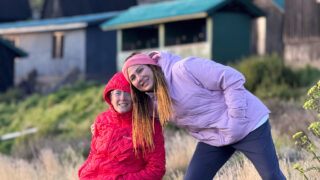 Sisters and Life Happens Outdoors regulars posing together at Horombo Hut during their Kilimanjaro trek.