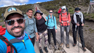 Life Happens Outdoors leader Anthony Mezher with his team at Horombo Hut on Kilimanjaro, taking a celebratory group selfie during their trek.