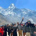 The LHO team, including Team Leader Rami Rasamny, at Ama Dablam Base Camp before their ascent on the Climb Ama Dablam Expedition with Life Happens Outdoors, with the peak standing clear behind them in perfect conditions.