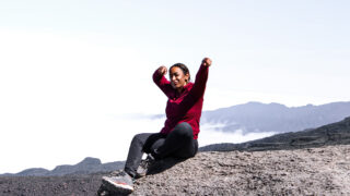 Life Happens Outdoors climber on Kilimanjaro’s Machame Route celebrating the successful ascent of the Barranco Wall.