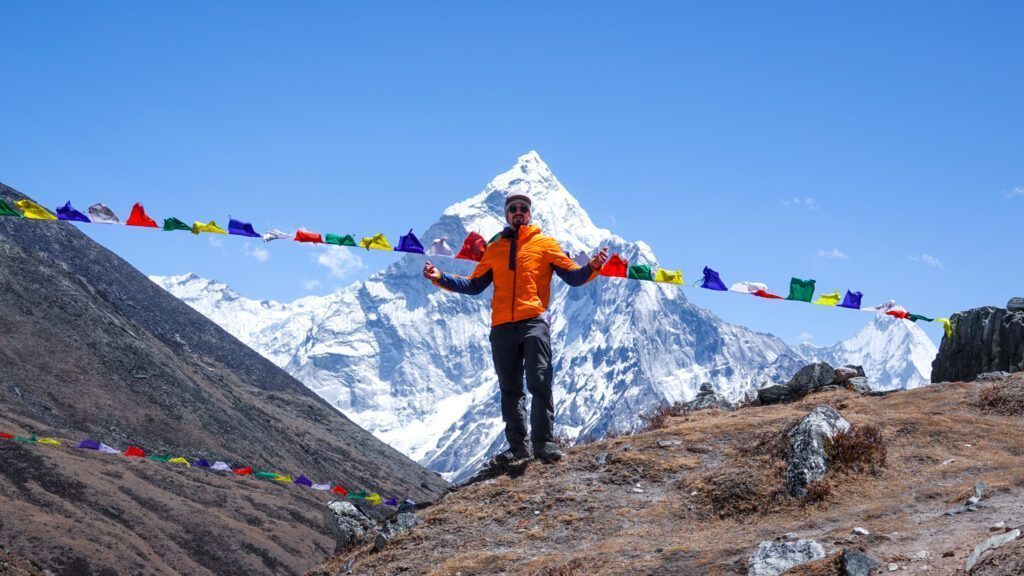 Zeid Shair at the Thukla Pass with Ama Dablam towering in the background during the Everest Base Camp Trek and the Climb Lobuche East Expedition with the Life Happens Outdoors team.