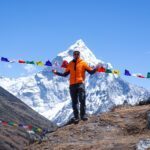 Zeid Shair at the Thukla Pass with Ama Dablam towering in the background during the Everest Base Camp Trek and the Climb Lobuche East Expedition with the Life Happens Outdoors team.