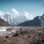 LHOer walking next to the lower Khumbu Glacier above Lobuche town on the day before reaching Everest Base Camp, with Cholatse and Thamserku in the background during the Everest Base Camp Trek with the Life Happens Outdoors team.