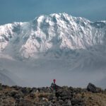 An epic capture of LHOer Hind Choueiry by LHO Team Leader and Founder Rami Rasamny, as she stands alone at the edge of the glacier moraine, showcasing the perspective of just how gigantic the South Face of Annapurna is during the Annapurna Base Camp Trek with the Life Happens Outdoors team.