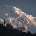 The glaciers of Annapurna South contrasted against the forests as seen from Jhinhu during the Annapurna Base Camp Trek with the Life Happens Outdoors team.