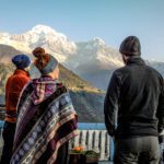 LHOers in Chomrong village at sunrise, with the Annapurna Sanctuary ahead of them in the valley and Annapurna South fully in view on the horizon during the Annapurna Base Camp Trek with the Life Happens Outdoors team.