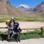 Nada Abanda and her daughter Anoud Gharaibeh at the start of the Aconcagua trail with the South Face of Aconcagua visible in the background during the Aconcagua Expedition with the Life Happens Outdoors team.