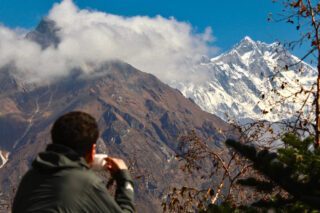 LHO Team Leader looking out towards Mount Lhotse and Everest from Phortse Tanga, the gateway to the Gokyo Valley, during the Gokyo Lakes Trek with the Life Happens Outdoors team.