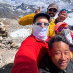 The Life Happens Outdoors team on the top of Renjo La pass with LHO Team Leader Hazem El Shamy, enjoying one of the best views of Mount Everest during the Gokyo Lakes Trek.