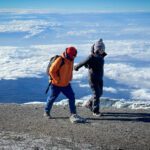 LHO Team Leader Hazem El Shamy and Leen Madanat on the final stretch to the Uhuru Peak summit of Kilimanjaro during the Climb Kilimanjaro Expedition with the Life Happens Outdoors team.