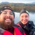 LHO Team Leader Bader Alsayyed and Hege, founder of Norwegian Wild, taking a selfie from the kayak with our coastal accommodation on the horizon during the Norway Arctic Adventure trip with the Life Happens Outdoors team.