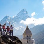 The Life Happens Outdoors team next to a Buddhist stupa with Ama Dablam in the background on the way to Dingboche during the Everest Base Camp Trek.