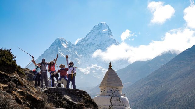 The Life Happens Outdoors team next to a Buddhist stupa with Ama Dablam in the background on the way to Dingboche during the Everest Base Camp Trek.
