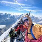 Jean Louis Moukarzel and IFMGA guide and Piolet d'Or winner Fred Degoulet on the summit of the Matterhorn with Monte Rosa in the background and beautiful views of the Zermatt Valley during the Climb Matterhorn Course with the Life Happens Outdoors team.