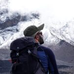 LHO Team Leader Jean Louis Moukarzel looking at the snow on the Kibo Crater from the top of the Baranco Wall on the Machame Route during the Climb Kilimanjaro expedition with the Life Happens Outdoors team.