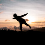 Life Happens Outdoors trekker striking a yoga pose on mount kilimanjaro
