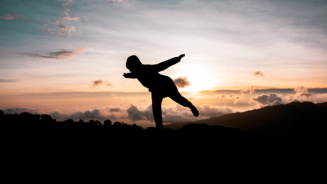 Life Happens Outdoors trekker striking a yoga pose on mount kilimanjaro