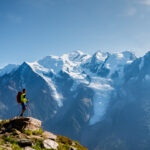LHOer looking at the Bossons Glacier and the summit of Mont Blanc from the Brévent region above the Chamonix Valley during the Mont Blanc Summit Course with the Life Happens Outdoors team.