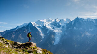 LHOer looking at the Bossons Glacier and the summit of Mont Blanc from the Brévent region above the Chamonix Valley during the Mont Blanc Summit Course with the Life Happens Outdoors team.