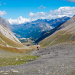on the tour du mont blanc hike, mountain peaks surround a valley below