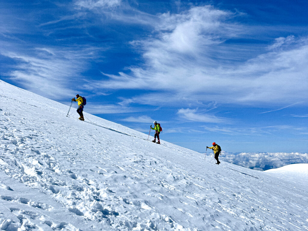 Life Happens Outdoors group climbing Mont Blanc near the summit ridge, showcasing the breathtaking glaciers of the Climb Mont Blanc adventure.