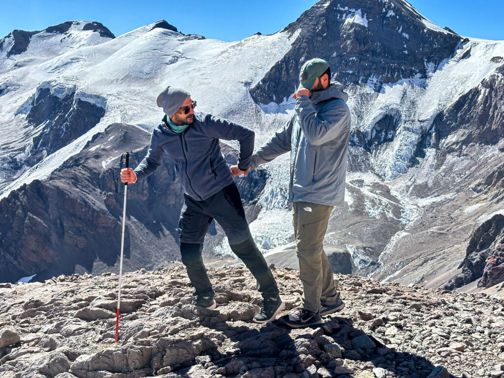 Frederik Sfeir and Khalil Chehab trading roles as the blind and sighted at Plaza Canadá, messing around with the incredible glaciers in the background during the Aconcagua Expedition with the Life Happens Outdoors team.