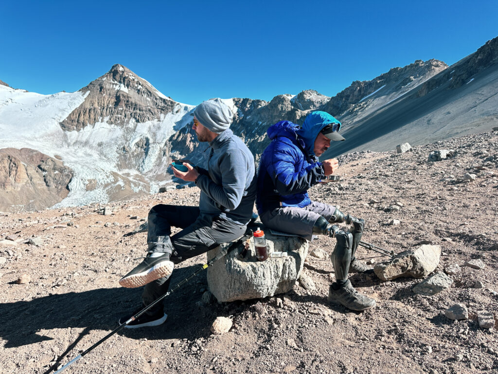 Hari Budha Magar, the first double over-the-knee amputee to climb Everest, having breakfast at Camp 1 with teammate Frederic Sfeir, who has retinitis pigmentosa, during their successful Aconcagua Expedition with the Life Happens Outdoors team.