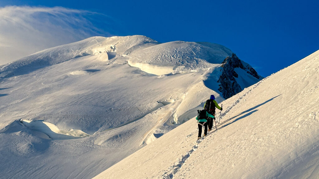 IFMGA guide Philippe Genin and the first Emirati woman to climb Mont Blanc, Fatima Sajwani, on the second mogul of Mont Blanc on the way to the summit during the Mont Blanc Summit Course with the Life Happens Outdoors team.