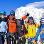 Roberto David, Carla Hachem, and Ranwa Zahr with IFMGA guides Lucia Guichot Martin and Babis Marinidis training on the Vallee Blanche with Mont Blanc in the background during Mont Blanc climbing preparation.
