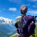 Life Happens Outdoors team member admiring Mont Blanc under clear summer skies during a Chamonix Mont Blanc adventure experience.