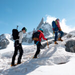 LHO climbers ascending a snowy alpine slope led by LHO senior guide Babis Marinidis during a beginner mountaineering expedition.