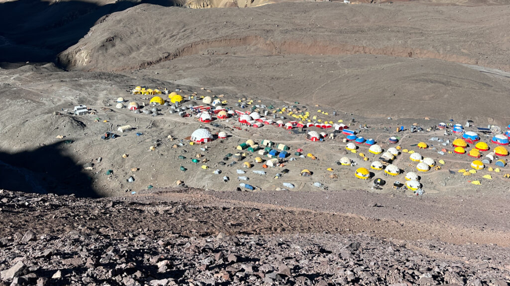 Aconcagua Base Camp tent city at Plaza de Mulas, showcasing the vibrant hub of climbers and expedition teams beneath the towering Andes.