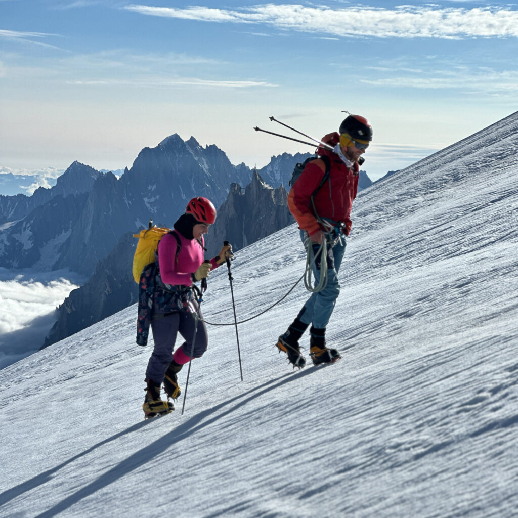 Two LHO climbers overlooking the dramatic Mont Blanc massif with panoramic views of the Chamonix Valley during their Mont Blanc climbing expedition