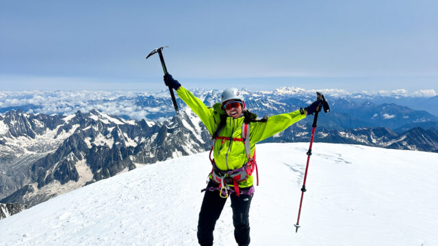 LHO team member standing on the Mont Blanc summit at sunrise, fully equipped with climbing gear after a successful Mont Blanc climb