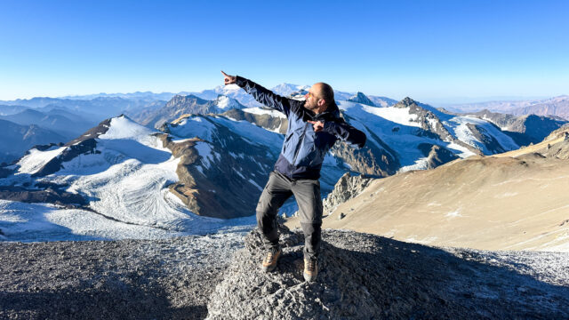 Frederic Sfeir at Camp 2 on Aconcagua with the Andes Mountains behind him during his climb with Life Happens Outdoors. Despite living with retinitis pigmentosa, Fred continues to defy limits on high altitude expeditions.
