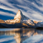 Sunrise on the Stellisee lake. Reflection of Matterhorn peak in the watter surface. Beautiful outdoor scene in Swiss Alps, Zermatt location, Valais canton, Switzerland, Europe.