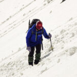 Life Happens Outdoors climber ascending rugged snowy slopes on Paldor Peak, showcasing sustainable adventure travel and zero waste practices.