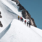 Life Happens Outdoors team ascending the moguls below the Mont Blanc summit during a Mont Blanc guided climb, showcasing skill and determination.