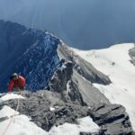 Jean Louis Moukarzel of Life Happens Outdoors ascending the narrow, snow-covered Mitellegi Ridge of the Eiger, surrounded by dramatic alpine peaks and deep valleys, capturing the challenge and beauty of his journey as recounted in the article "Am I an Alpinist?