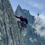 LHO Team Leader Gino Traboulsi climbing a granite route in Chamonix with Mont Blanc peaks in the background, showcasing balance, focus, and the Life Happens Outdoors spirit of transformation.