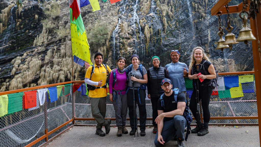 Life Happens Outdoors community members trekking toward the high-altitude environment of the Annapurna Sanctuary, surrounded by towering Himalayan peaks and alpine terrain.