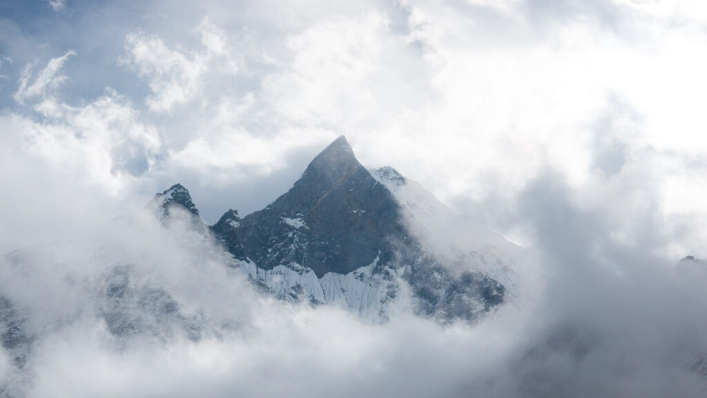 Fishtail Mountain emerging through the clouds as seen from Annapurna Base Camp in Nepal.
