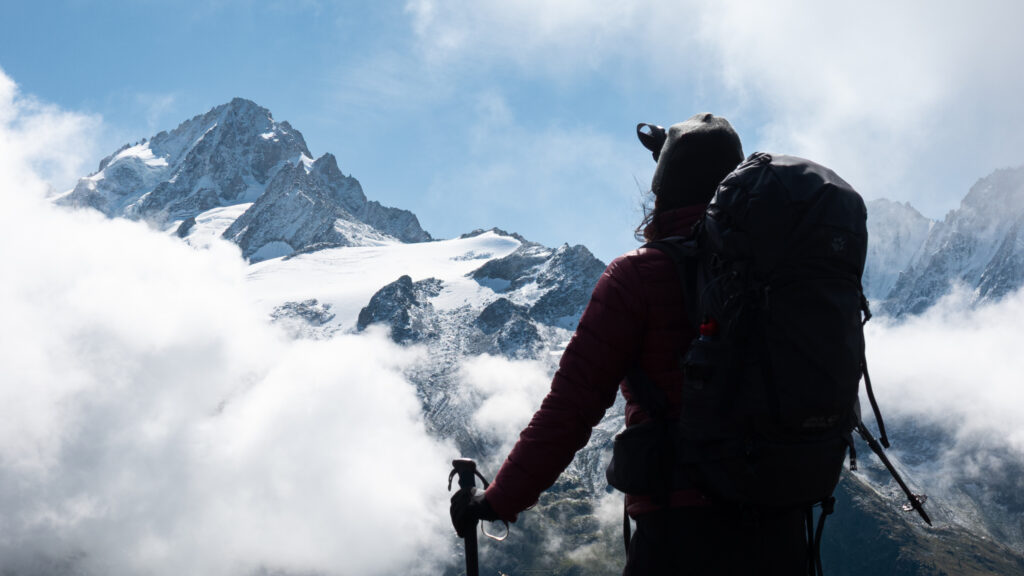 Life Happens Outdoors community member trekking the Tour du Mont Blanc and admiring the snowy peaks of the Mont Blanc massif.