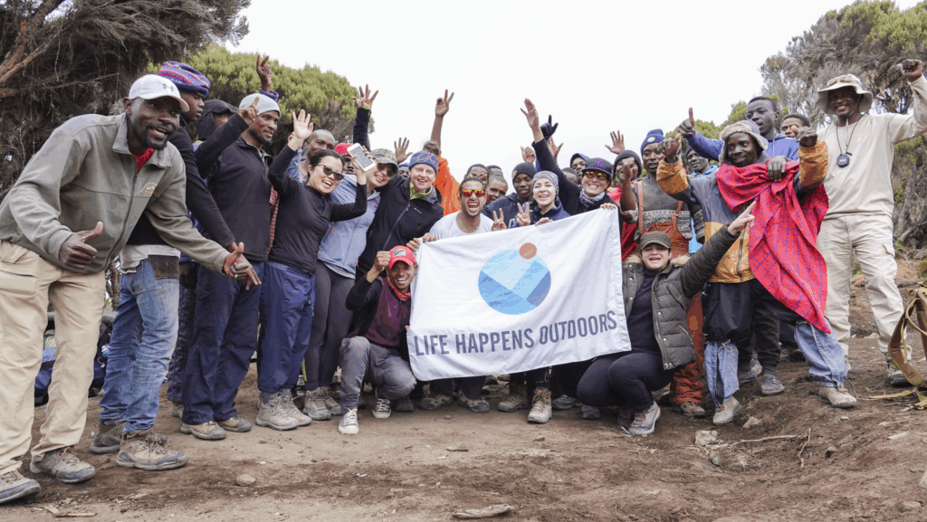 Full Life Happens Outdoors team and support staff celebrating the end of the Mount Kilimanjaro climb in Tanzania