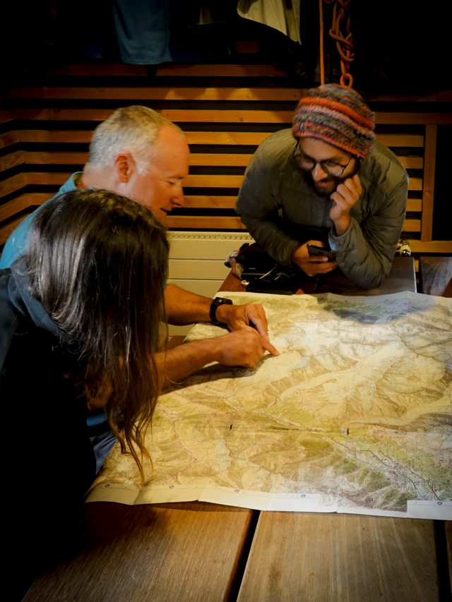 Life Happens Outdoors corporate joiners and their guide review a map and discuss the day’s objective during a corporate adventure retreat planning session