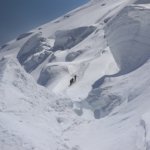 Three Life Happens Outdoors climbers on the Mont Blanc summit push, crossing the third boss in clear weather with glaciers all around