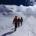 Life Happens Outdoors climbers beneath the Dôme du Goûter on the approach to the Goûter Hut during a Mont Blanc climb